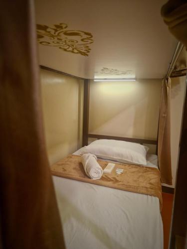 a small bed in a small room with at Park Avenue Boutique Hotel Manila in Manila