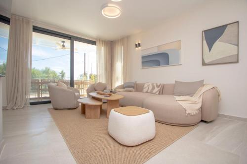 a living room with a couch and chairs and a table at Daroma Villa, Paliouri by Halkidiki Villas in Paliouri