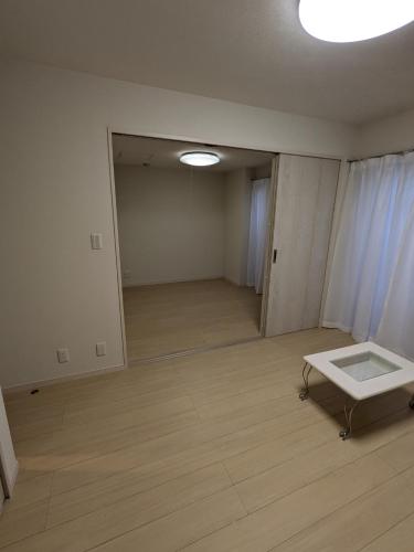 an empty room with a window and a table in it at amuseria in Kyoto