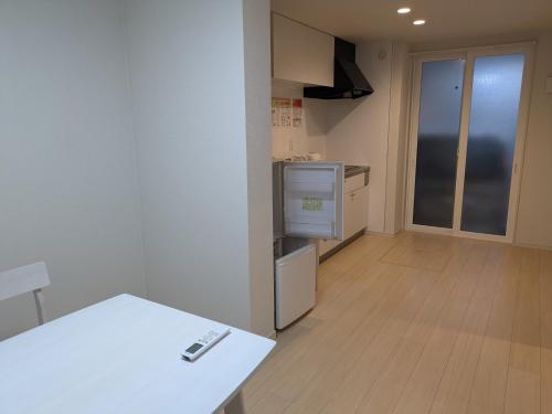 a kitchen with a white counter and a white table at amuseria in Kyoto