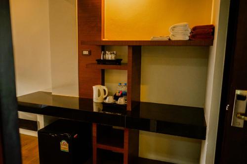 a hotel room with a counter with towels on it at Am Samui Palace in Lamai