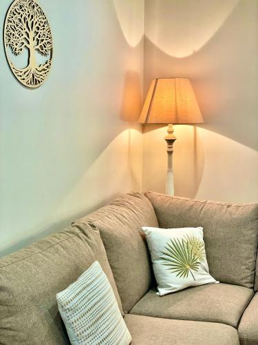 a living room with a couch and a lamp at " Ô Chai Nous " 14 pers - Billard, Babyfoot - Structure de Jeux in Poucharramet