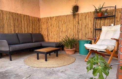 a living room with a couch and a chair at La casina di mezzo - Tiny House in Camaiore