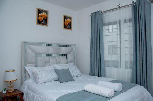 Ένα ή περισσότερα κρεβάτια σε δωμάτιο στο Chic 2BR Nairobi-Tatu City Suite