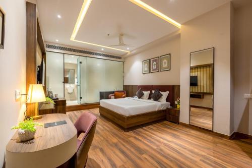 a hotel room with a bed and a table at Saltstayz Premier Suite Chandigarh Mohali in Sohāna