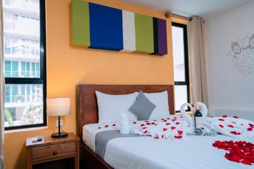 a bedroom with a bed with red roses on it at Home Chic Hotel in Phnom Penh