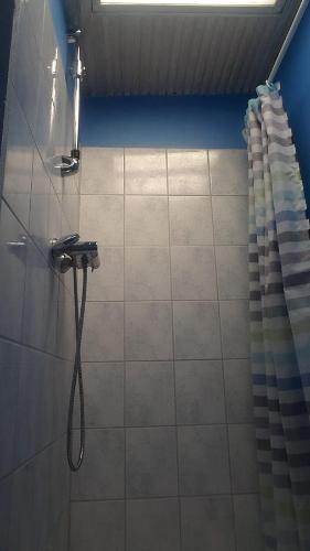 a shower in a bathroom with a shower curtain at Room In Gedser Centrum in Gedser