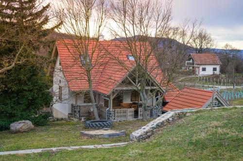 an old house with an orange roof on a hill at Hill & Chill in Káptalantóti