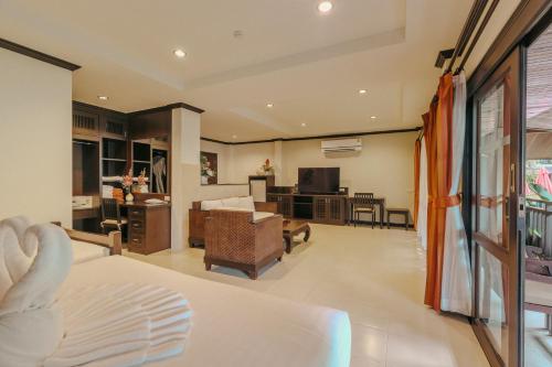 a room with a living room and a kitchen at Am Samui Palace in Lamai