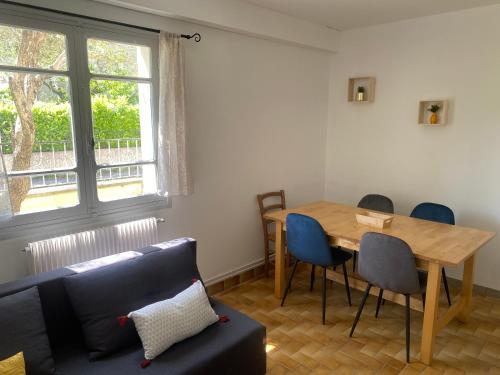 un salon avec une table et un canapé dans l'établissement Chez Laura et Nans, à Saint-Laurent-dʼAigouze