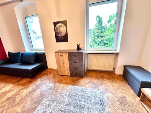 a living room with two couches and a large window at HONOR - Urban Peace Linz in Linz