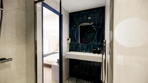 a bathroom with a sink and a mirror at Villa Onyra - Studios, Suites & Villa in Saint-Cyr-sur-Mer