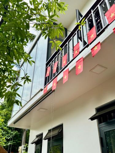 a building with pink signs on the side of it at Live like a local Homestay in Ấp Tư Tây