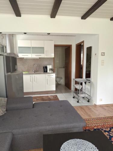a living room with a couch and a kitchen at Ferienhaus Elbe -Parey am See in Parey