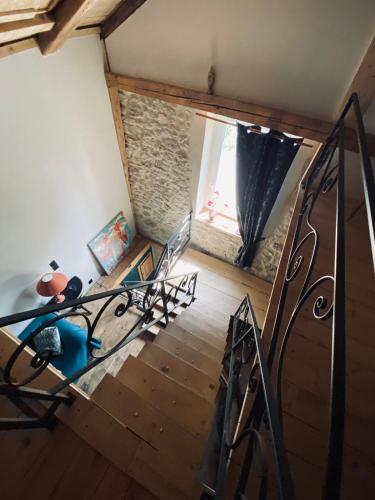 an attic room with a bed and a window at L'instant présent in Echallon