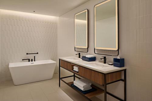 a white bathroom with a sink and a mirror at Hyatt Place Ha Long Bay, Bai Chay in Ha Long