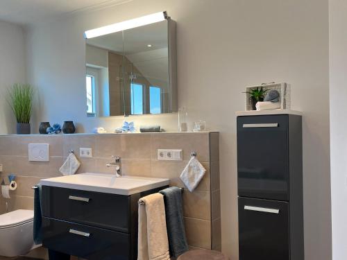 a bathroom with a sink and a mirror at Ferienwohnung Klosterblick in Öhningen