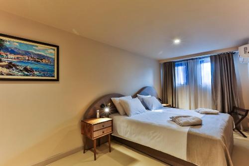 a bedroom with a bed and a window at Boutique hotel Ruzmarin SPA & Garden by Aycon in Budva