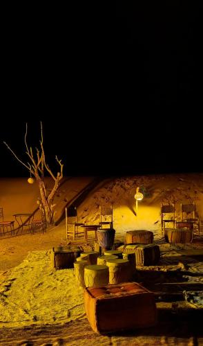 a stage in the middle of a desert at night at Najma Luxury Camp in Merzouga