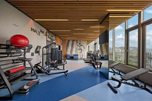 a gym with several tread machines and a large window at Hyatt Place Ha Long Bay, Bai Chay in Ha Long