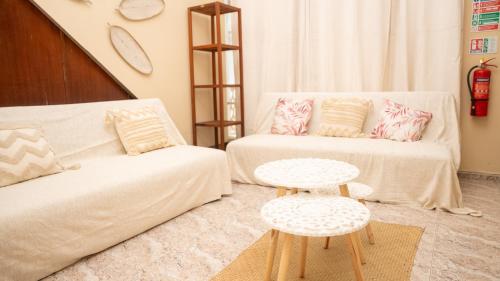a living room with a couch and a table at Ti Caz Mathurin in Port Mathurin