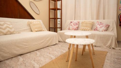a living room with a couch and a table at Ti Caz Mathurin in Port Mathurin