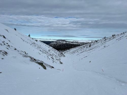 a snow covered hillside with a road in the snow at Ylläs Chalet 4 Ski-In, Incl 2 winter lift passes in Ylläsjärvi