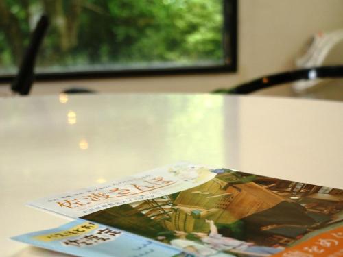 a table with a book on top of it at Ryokan Kamomeso in Sado