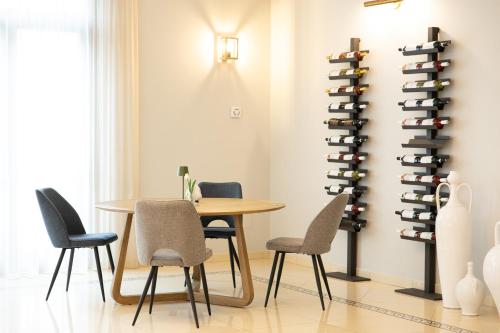 a dining room with a table and chairs and a wine rack at UNICO Albatres Palace Salento by Life Resorts in San Vito dei Normanni