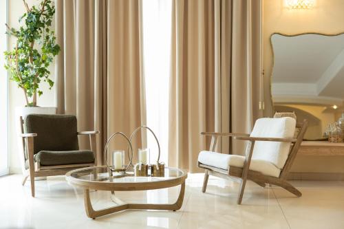 a living room with two chairs and a coffee table at UNICO Albatres Palace Salento by Life Resorts in San Vito dei Normanni
