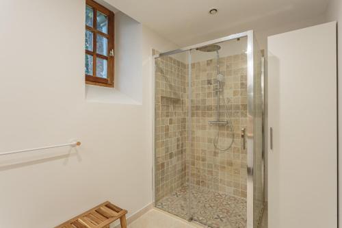 a bathroom with a shower with a glass door at Domaine Le Pehau 4 - Avec jardin et terrasse in Osserain-Rivareyte