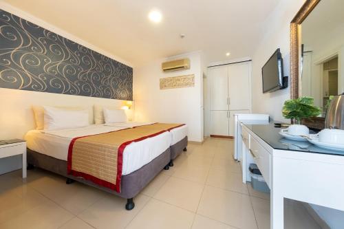Ένα ή περισσότερα κρεβάτια σε δωμάτιο στο Tropic Beach Club & Resort - Side
