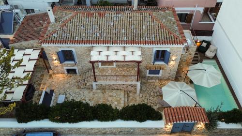 an aerial view of a house with a swimming pool at Aeolian Stone Villa in Koilás