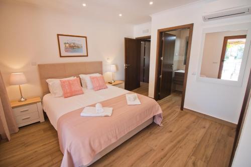 a bedroom with a bed with two trays on it at Casa da Ladeira Branca in Lagos
