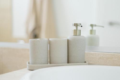a bathroom sink with three rolls of toilet paper at Apartamento Casa Gallardo in Blanes