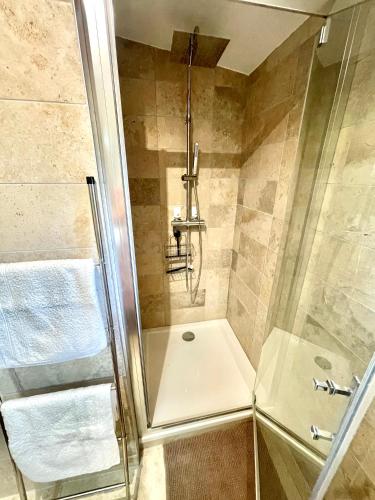 a shower with a glass door in a bathroom at " Ô Chai Nous " 14 pers - Billard, Babyfoot - Structure de Jeux in Poucharramet