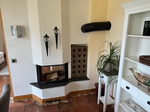 a living room with a fireplace in the wall at Drostenhaus Feldberg in Feldberg