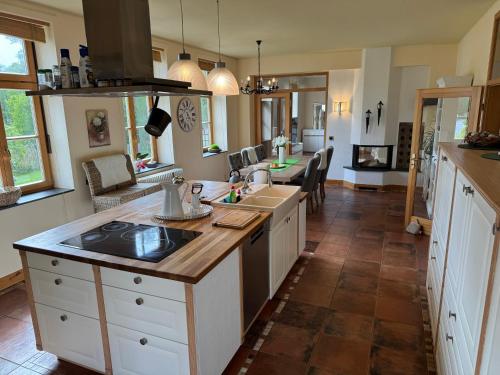 a kitchen with white cabinets and a counter top at Drostenhaus Feldberg in Feldberg