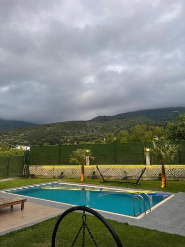 a swimming pool with a view of the mountains at Villa akça in Masukiye