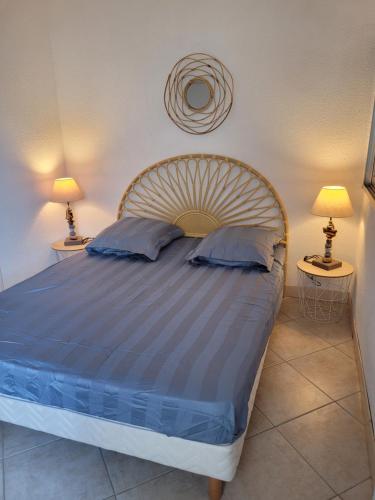 une chambre avec un grand lit avec deux lampes dans l'établissement Plage à pied, au Barcarès