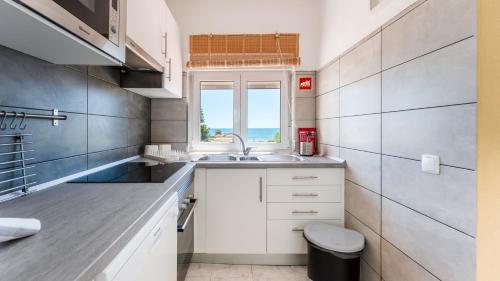 a kitchen with a sink and a window at Star Paradise in Armação de Pêra