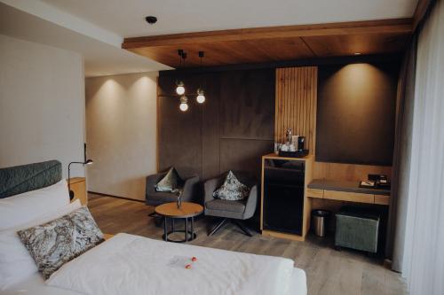 a hotel room with a bed and a table and chairs at Hotel Wagnerhof in Pertisau