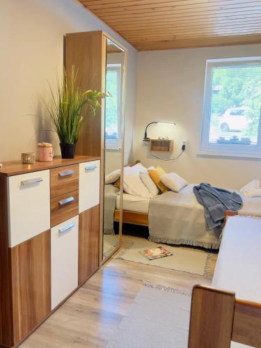 a bedroom with a mirror and a bed at Napkelte Vendégház in Szigliget