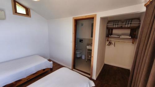 a small room with a bed and a bathroom at Olive Garden Kabak in Faralya