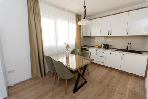 a kitchen with a dining room table and chairs at Villa Hanna Ilidža in Kamenjača