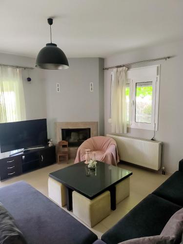 a living room with a couch and a table at Zak's House in Platamonas