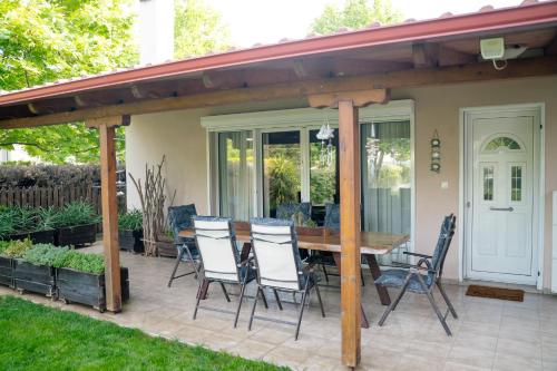 a patio with a wooden table and chairs at Zak's House in Platamonas