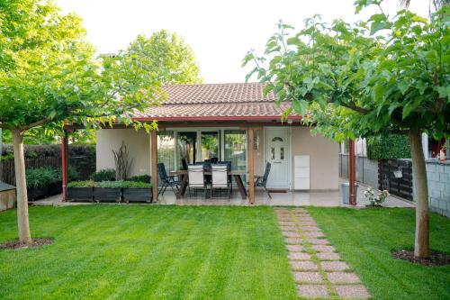 a patio with a table and chairs in a yard at Zak's House in Platamonas