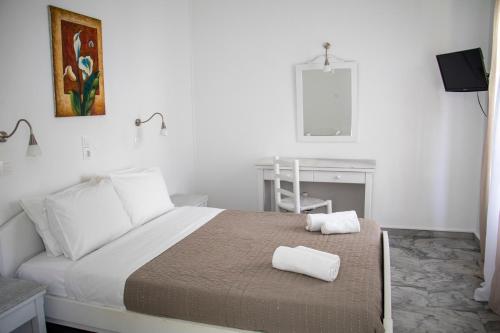 Postel nebo postele na pokoji v ubytování Hotel Manos