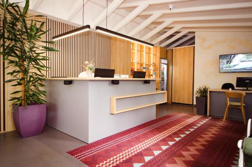 an office with a reception desk and a potted plant at Turističko naselje Natura Art-Hotel Opal Art in Lohovo